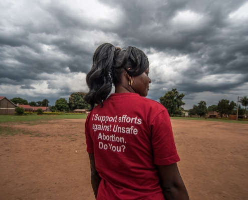 Milly Namulindwa, a teacher and VODA community volunteer, wears a t-shirt advocating for safe abortions in Kasawo, Uganda.