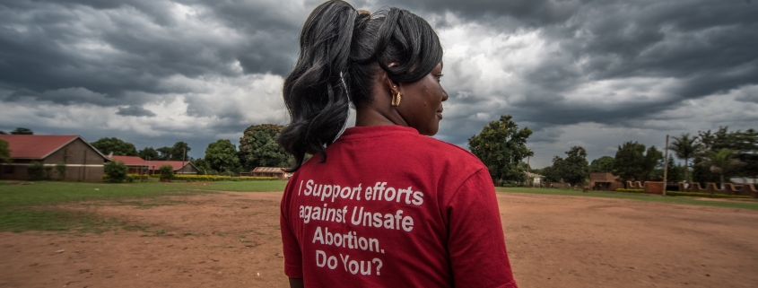 Milly Namulindwa, a teacher and VODA community volunteer, wears a t-shirt advocating for safe abortions in Kasawo, Uganda.