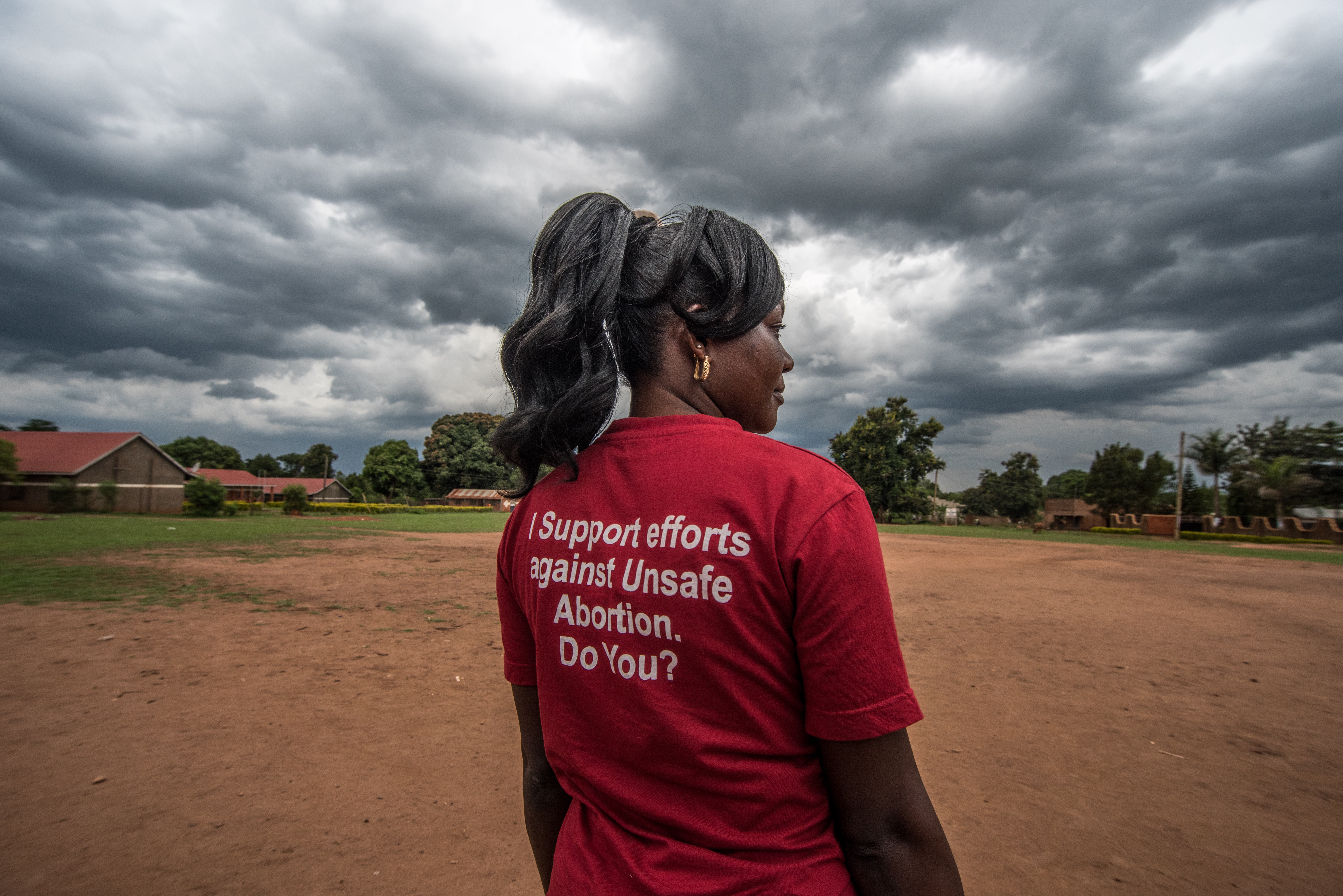 Milly Namulindwa, a teacher and VODA community volunteer, wears a t-shirt advocating for safe abortions in Kasawo, Uganda.